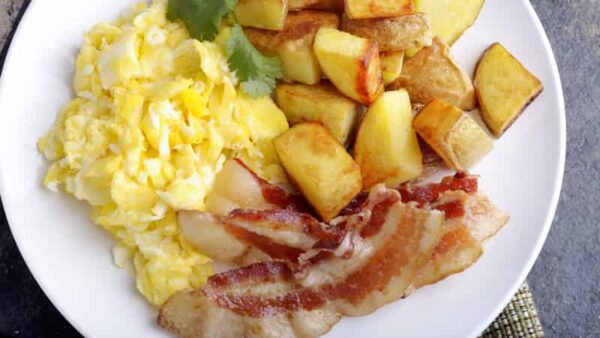 Classic breakfast- creamy scrambled eggs, house potatoes, bacon or sausage, fresh fruit & breakfast pastries